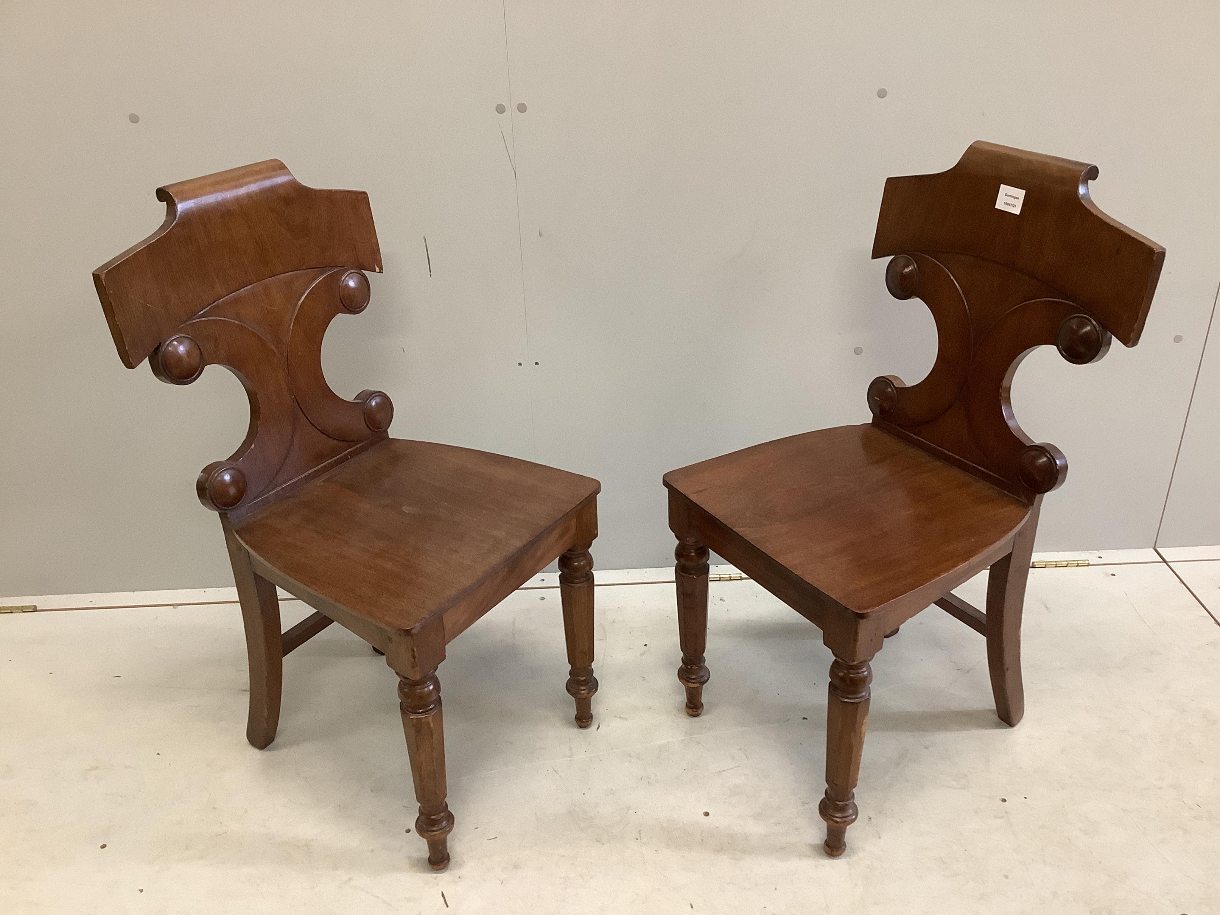 A pair of Victorian mahogany hall chairs, width 44cm, depth 40cm, height 88cm. Condition - fair